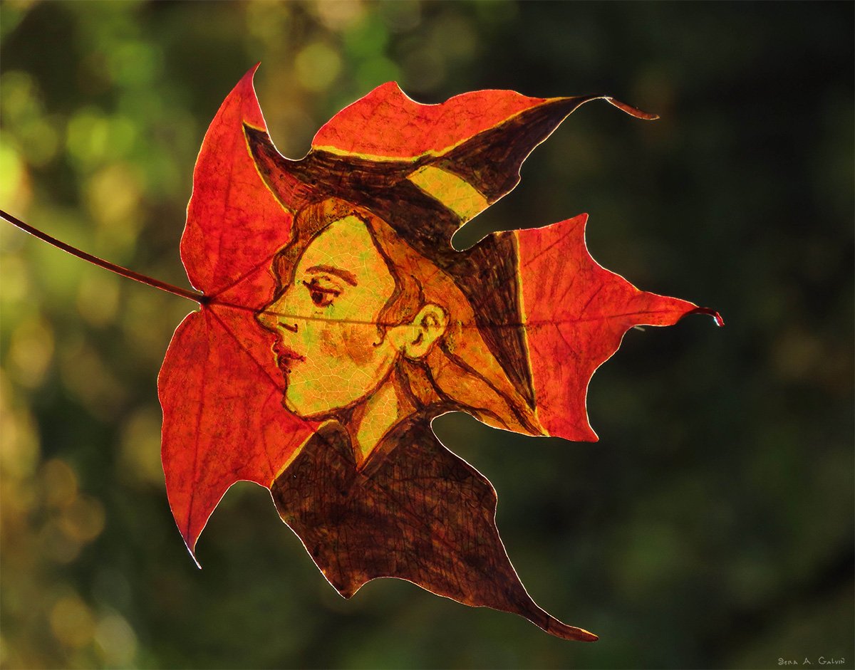 Profile portrait of a witch in a pointed hat, drawn on a red maple leaf against green forest bokeh, by Sera Autumn