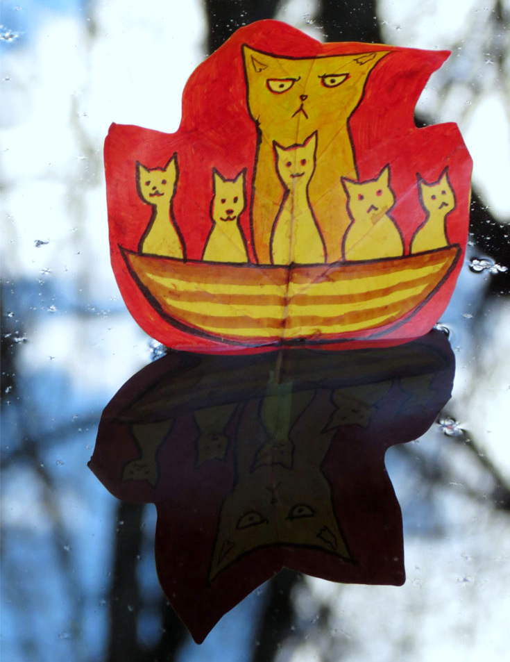 A grumpy yellow cat and five kittens riding a boat, drawn on a red maple leaf, reflected in water below, by Sera Autumn