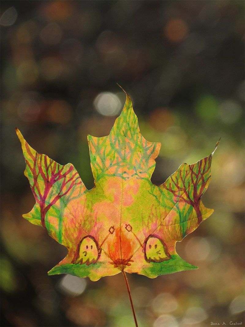 A green-and-gold maple leaf drawn with two little ghosts roasting marshmallows over a campfire in a forest, backlit by bokeh, by Sera Autumn