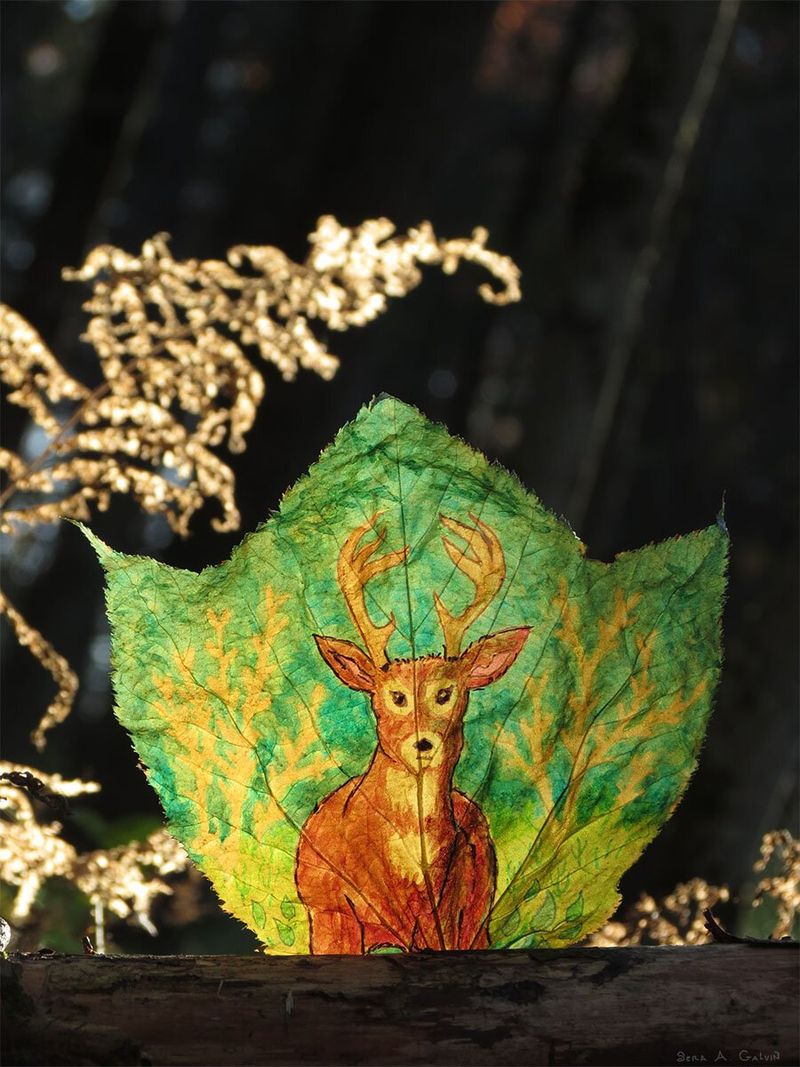 A brown antlered stag deer drawn on a teal and gold leaf, set against dark forest with golden dried grasses, by Sera Autumn