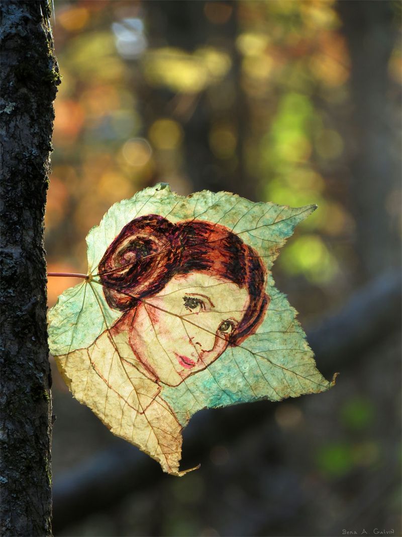 Carrie Fisher as Princess Leia on a pale green and cream leaf, against golden forest bokeh, by Sera Autumn